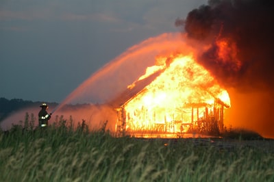Firefighters spray on the burning house
